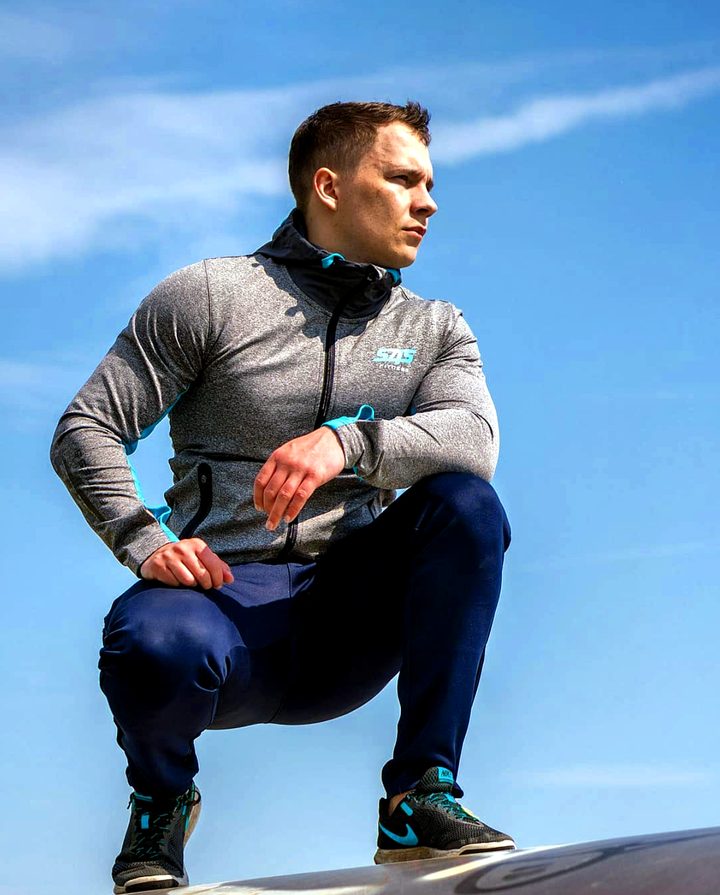 The hoodie worn outdoors against a blue sky